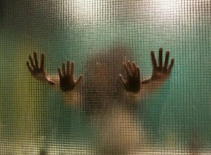Indistinct figures, engaging in the ol' "hide the salami" game, press their hands against a steamed up window.