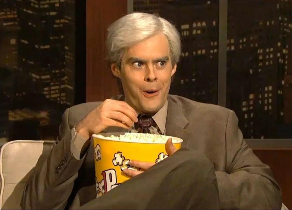 Guy with popcorn looking forward to the shitshow